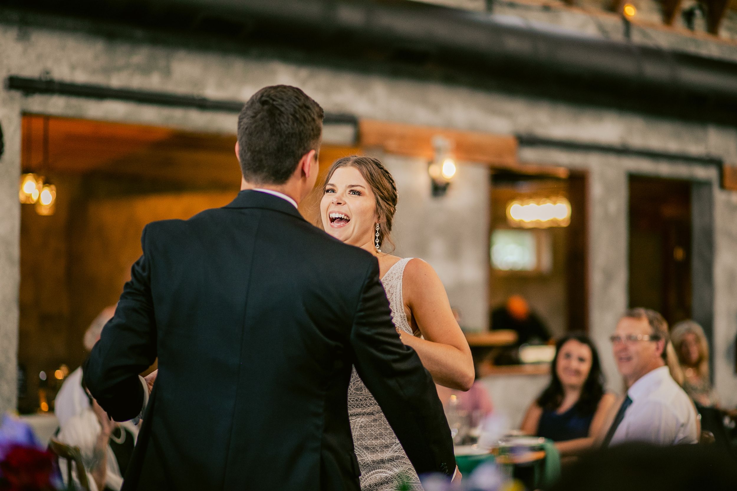 A couple shares an intimate dance moment at their wedding reception.