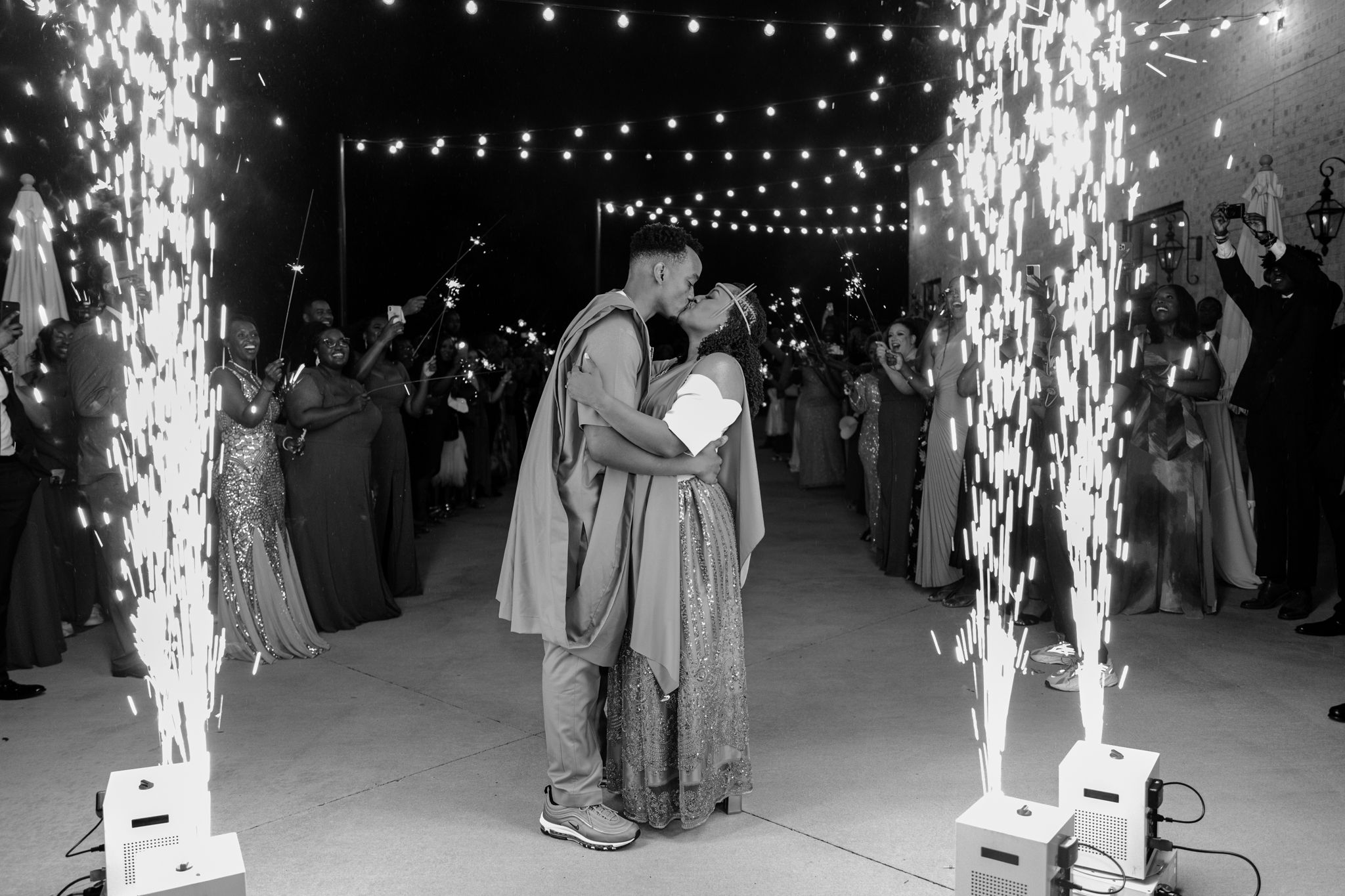 A series of black and white photographs showing sparklers and fireworks at a nighttime celebration or event.