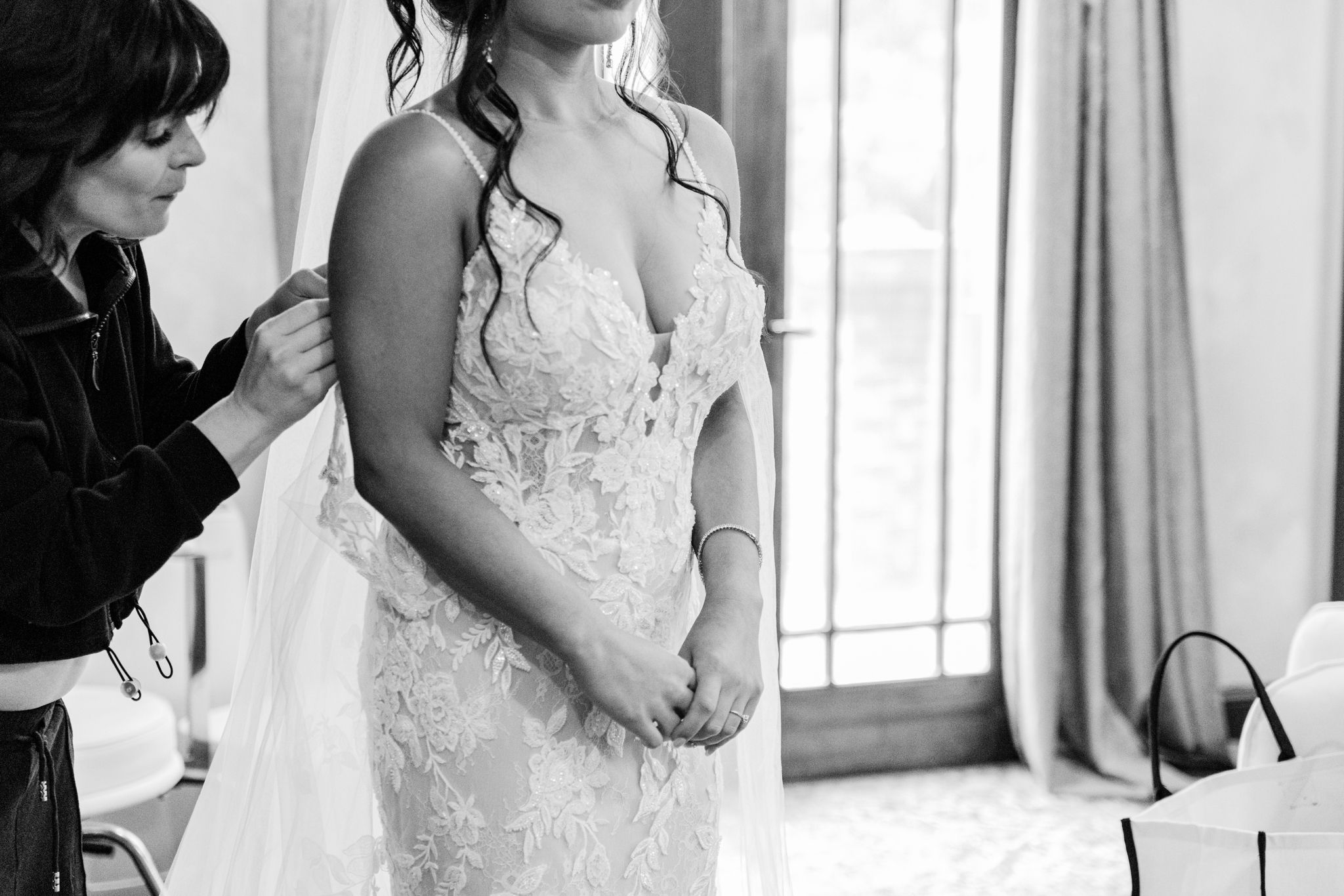 A series of black and white photos showing preparations for a wedding ceremony with elegant formal attire.
