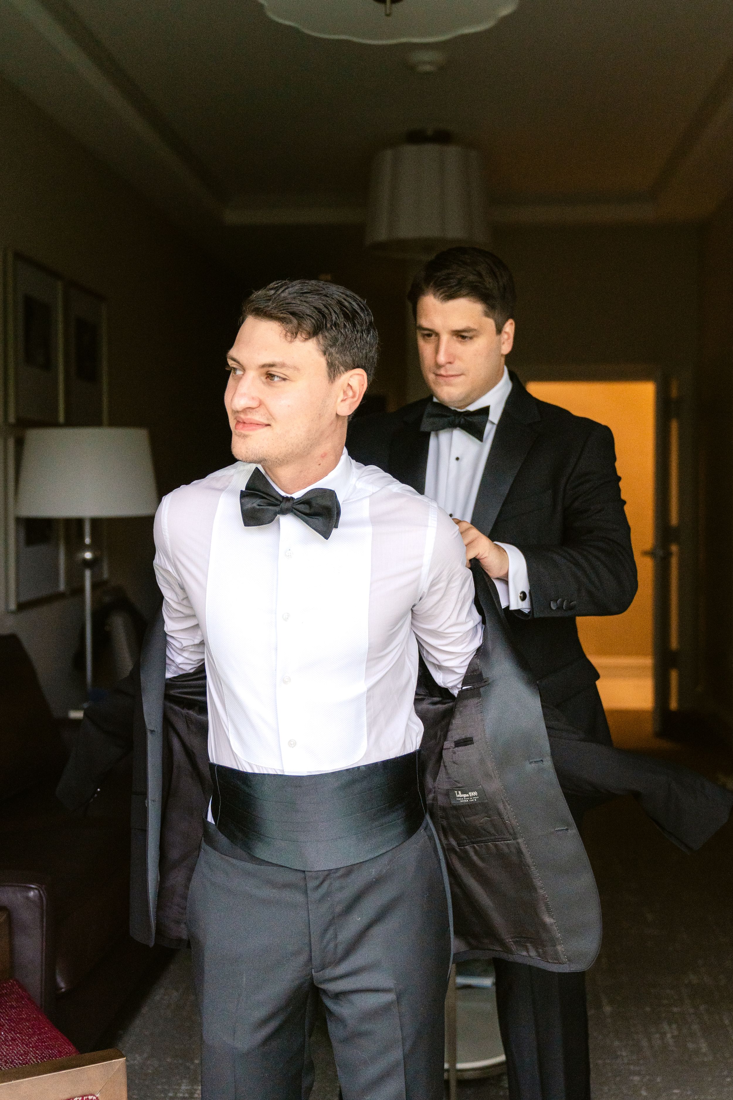 Multiple shots of people getting dressed in formal attire with bow ties and white shirts.