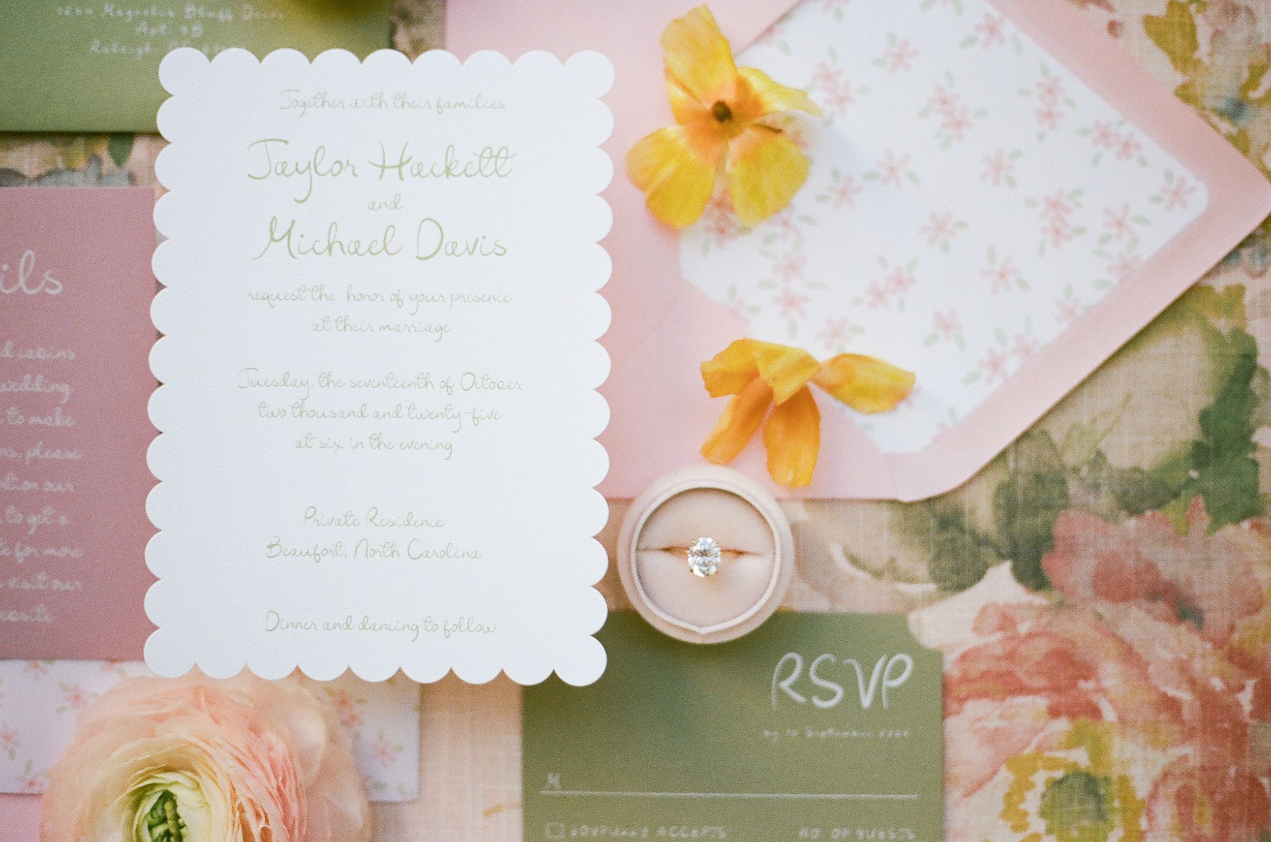 Wedding stationery suite featuring scalloped invitations with yellow flowers and wooden button details.